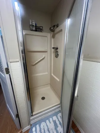 a bathroom with a glass door shower