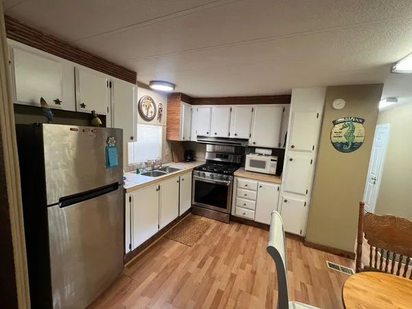 a kitchen with a refrigerator a sink dishwasher and a stove top oven