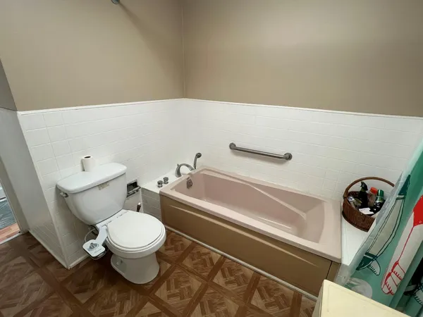 a bathroom with a toilet and a bathtub