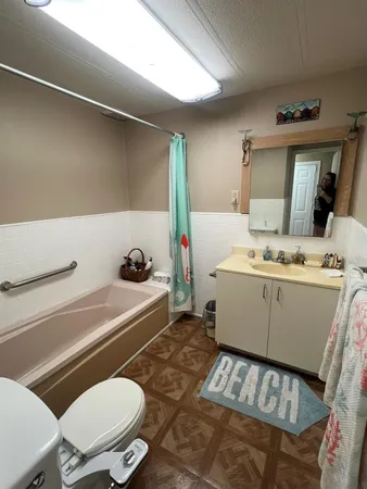 a bathroom with a sink mirror vanity and toilet