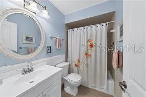 a bathroom with a sink vanity mirror and toilet