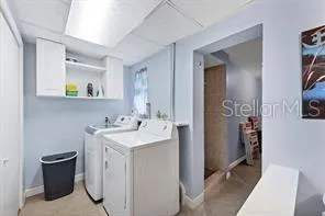 a view of hallway with sink and wooden floor