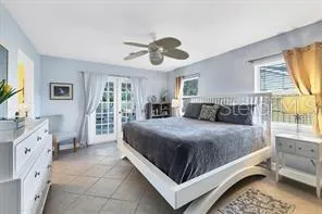 a bedroom with a large bed and a chandelier