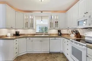 a kitchen with sink cabinets and window