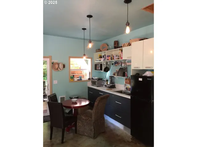 a view of barbeque grill with a sink and cabinets