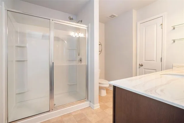 a bathroom with a glass shower door