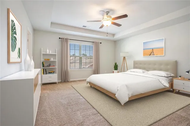 a bedroom with a large bed and a chandelier