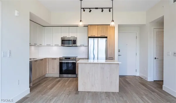 a kitchen with a wooden floor and a stove top oven