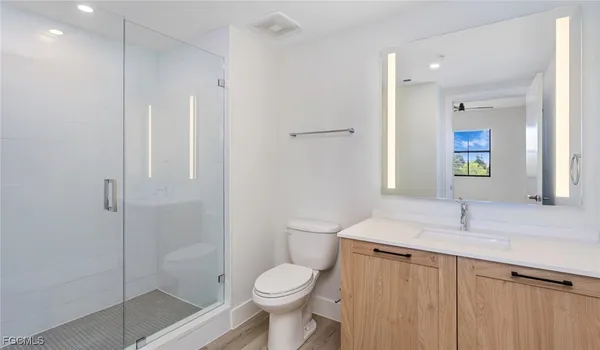 a bathroom with a sink toilet and shower