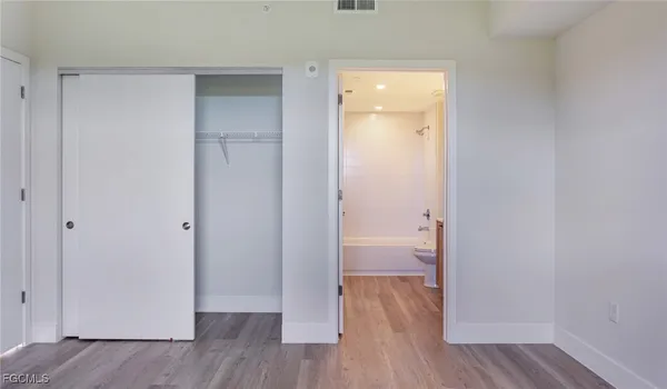 a view of room with wooden floor