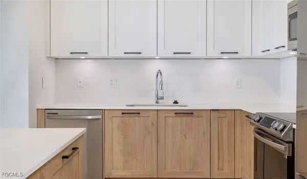 a view of kitchen with white cabinets