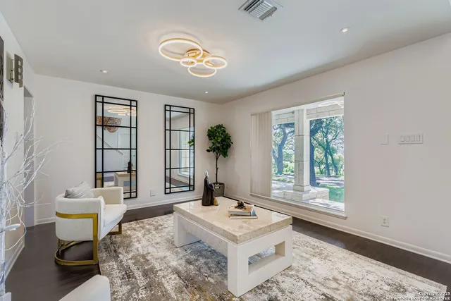 a living room with furniture and next to a window