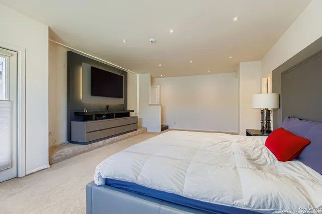 a bedroom with a bed and a flat screen tv