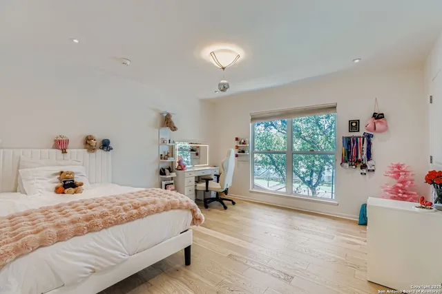 a bedroom with a bed and a large window
