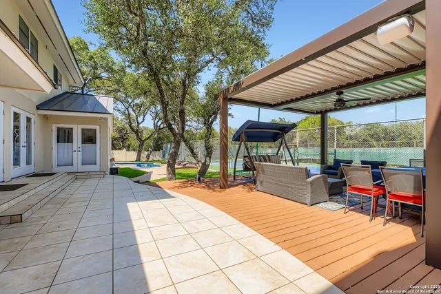a patio with a table and chairs under an umbrella