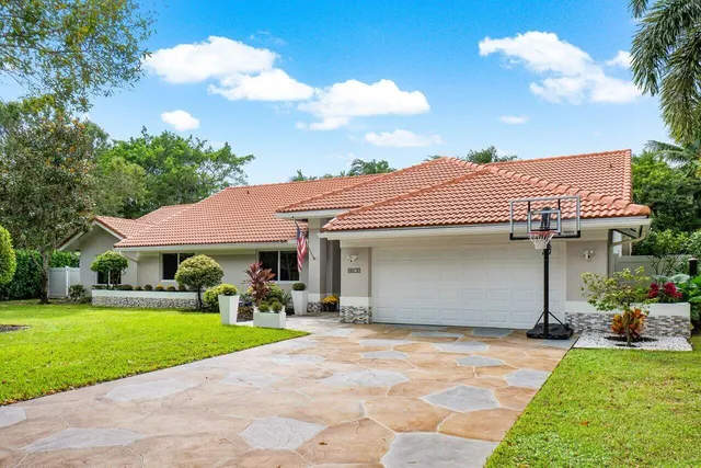 a kitchen with stainless steel appliances granite countertop a refrigerator a stove and a sink