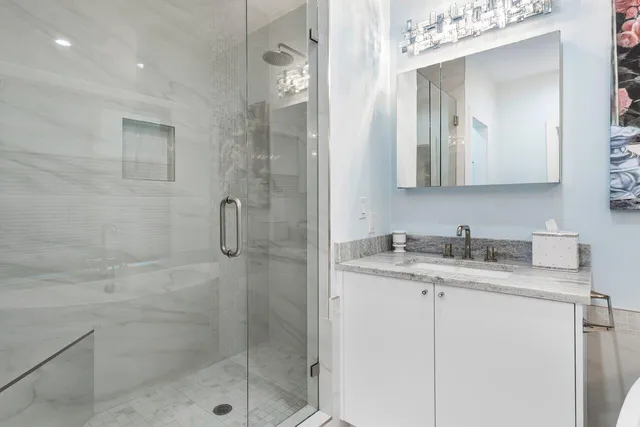 a view of kitchen with stainless steel appliances wooden floor