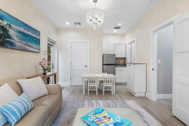 a view of a patio with table and chairs and potted plants