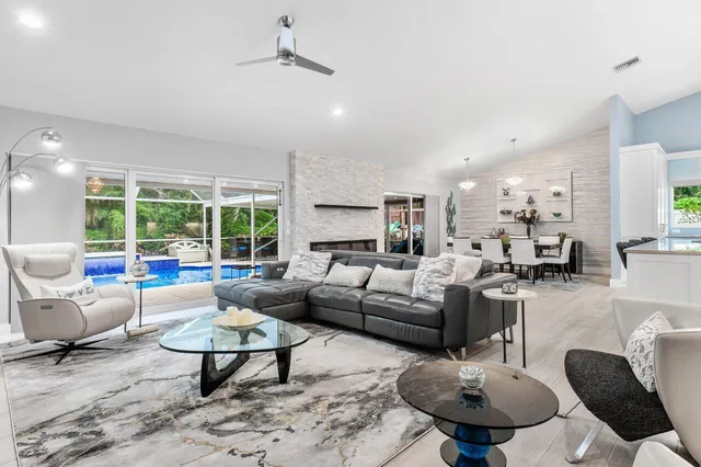 a view of a living room with furniture and wooden floor