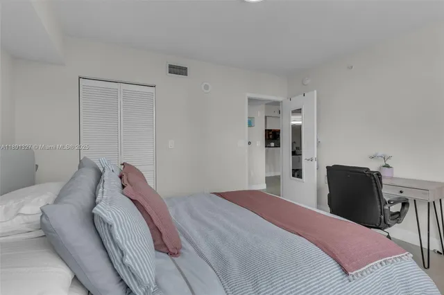 a bedroom with a bed and chair