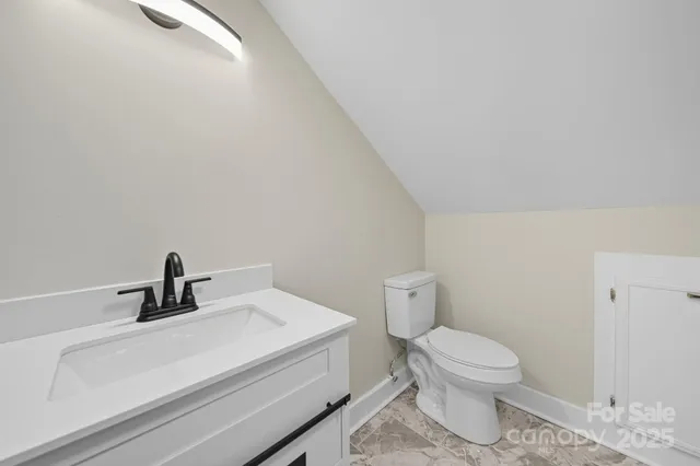 a bathroom with a sink a toilet and mirror