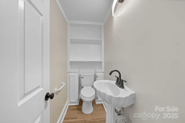 a bathroom with a sink toilet and a mirror