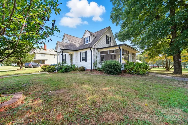 a view of a house with yard and a garden