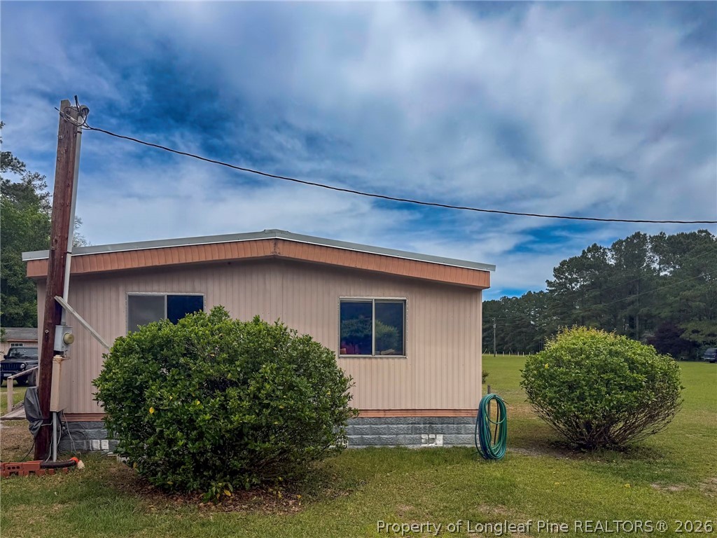 1308 Mac D Road Orrum, NC 28369 - Photo 23 of 32 a view of a house with a yard