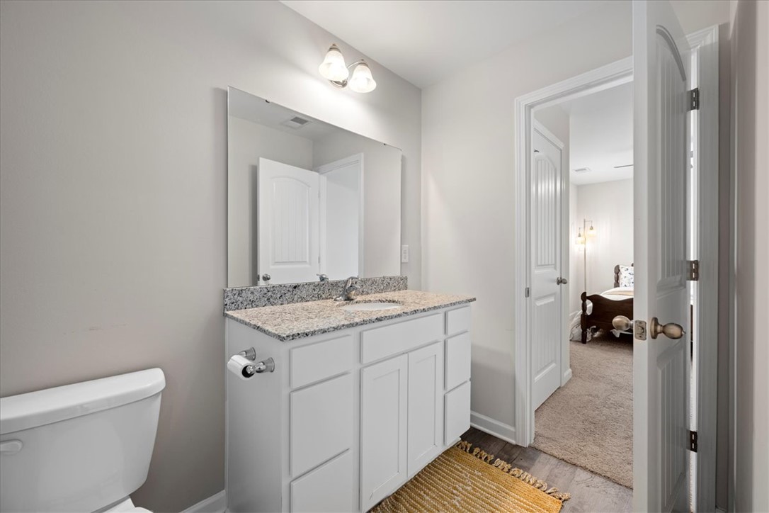 117 Adger Road Pendleton, SC 29670 - Photo 24 of 36 This bathroom features a contemporary vanity with a granite countertop and a spacious mirror.