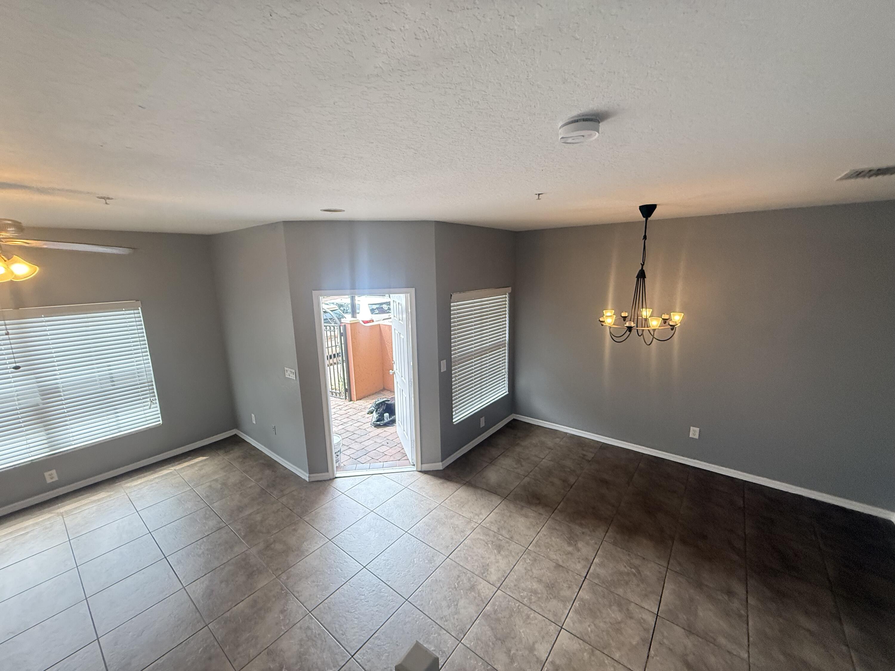 2851 Prospect Road, Unit 502 Tamarac, FL 33309 - Photo 11 of 17 an empty room with fireplace and windows