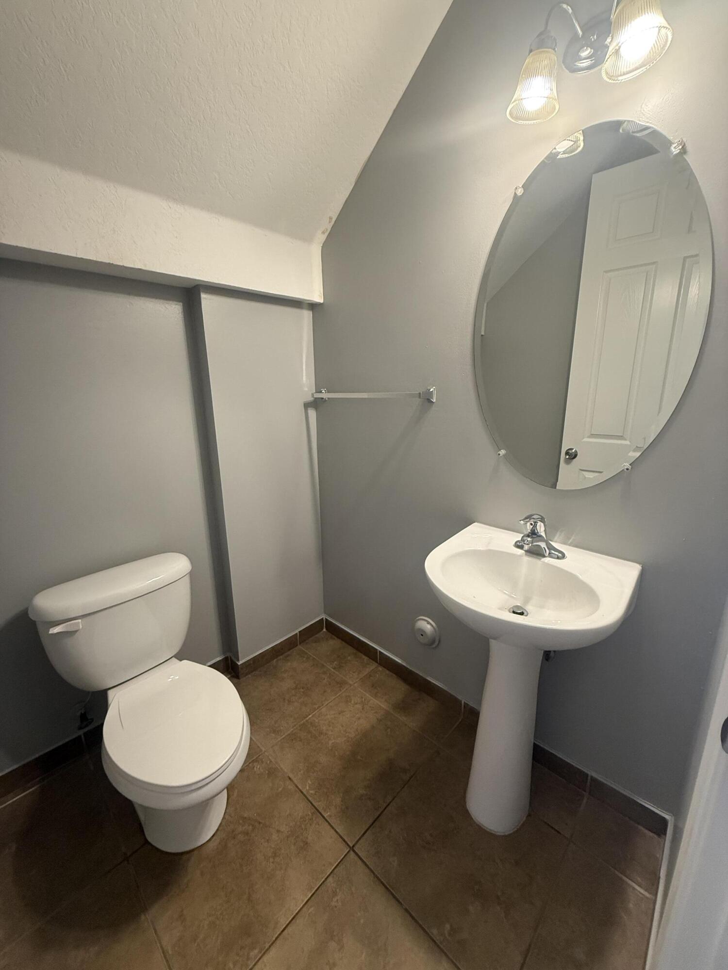 2851 Prospect Road, Unit 502 Tamarac, FL 33309 - Photo 17 of 17 a bathroom with a sink a mirror and a toilet