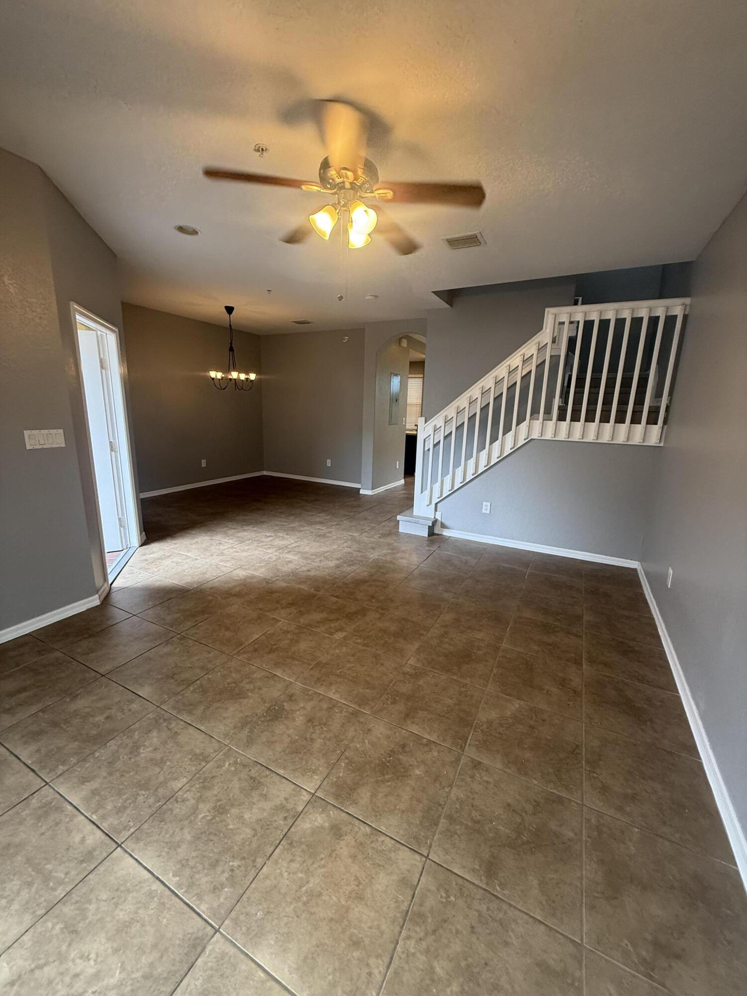 2851 Prospect Road, Unit 502 Tamarac, FL 33309 - Photo 3 of 17 a view of an empty room with chandelier fan and a window