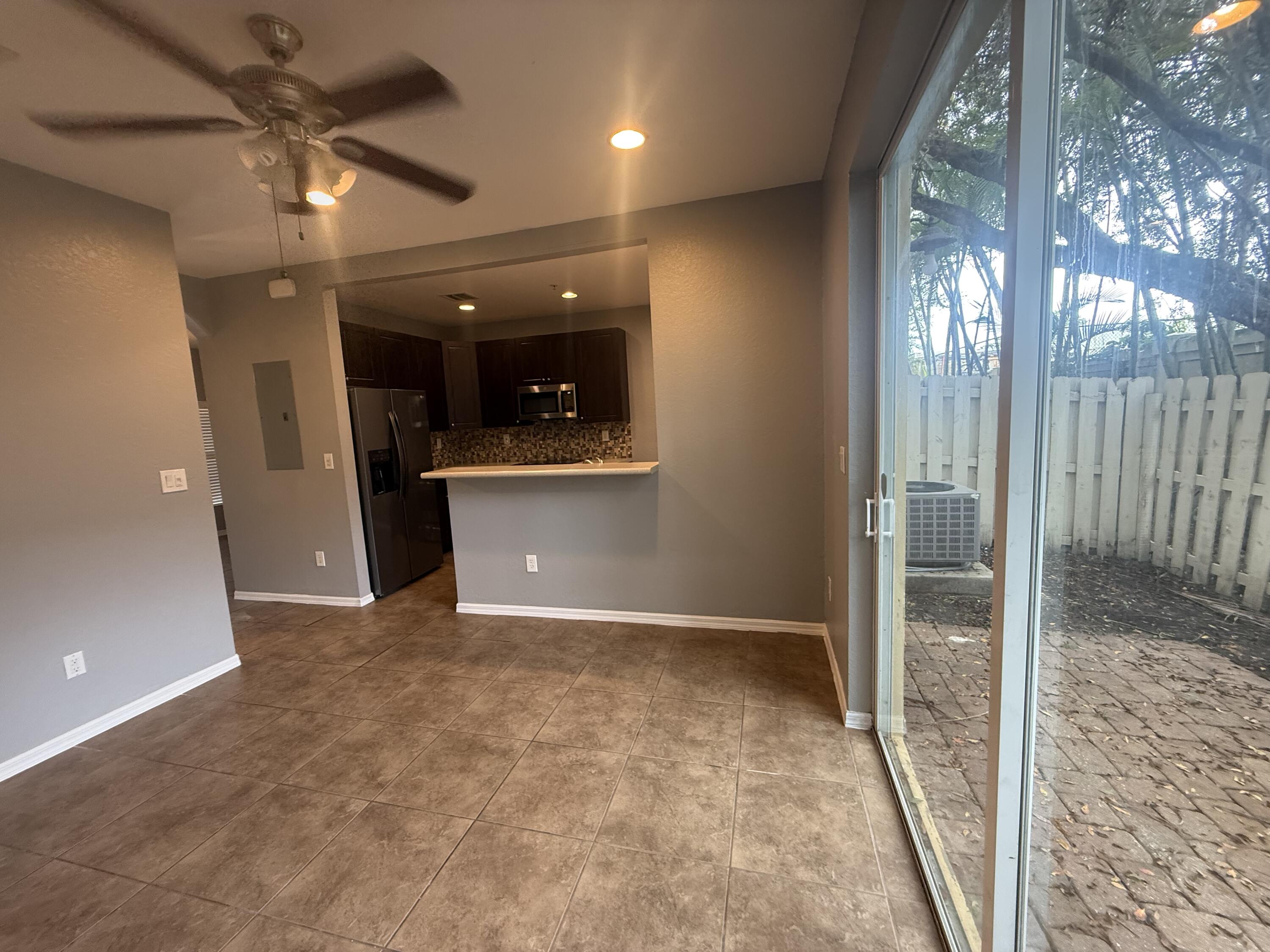 2851 Prospect Road, Unit 502 Tamarac, FL 33309 - Photo 5 of 17 en empty room with windows and entrance