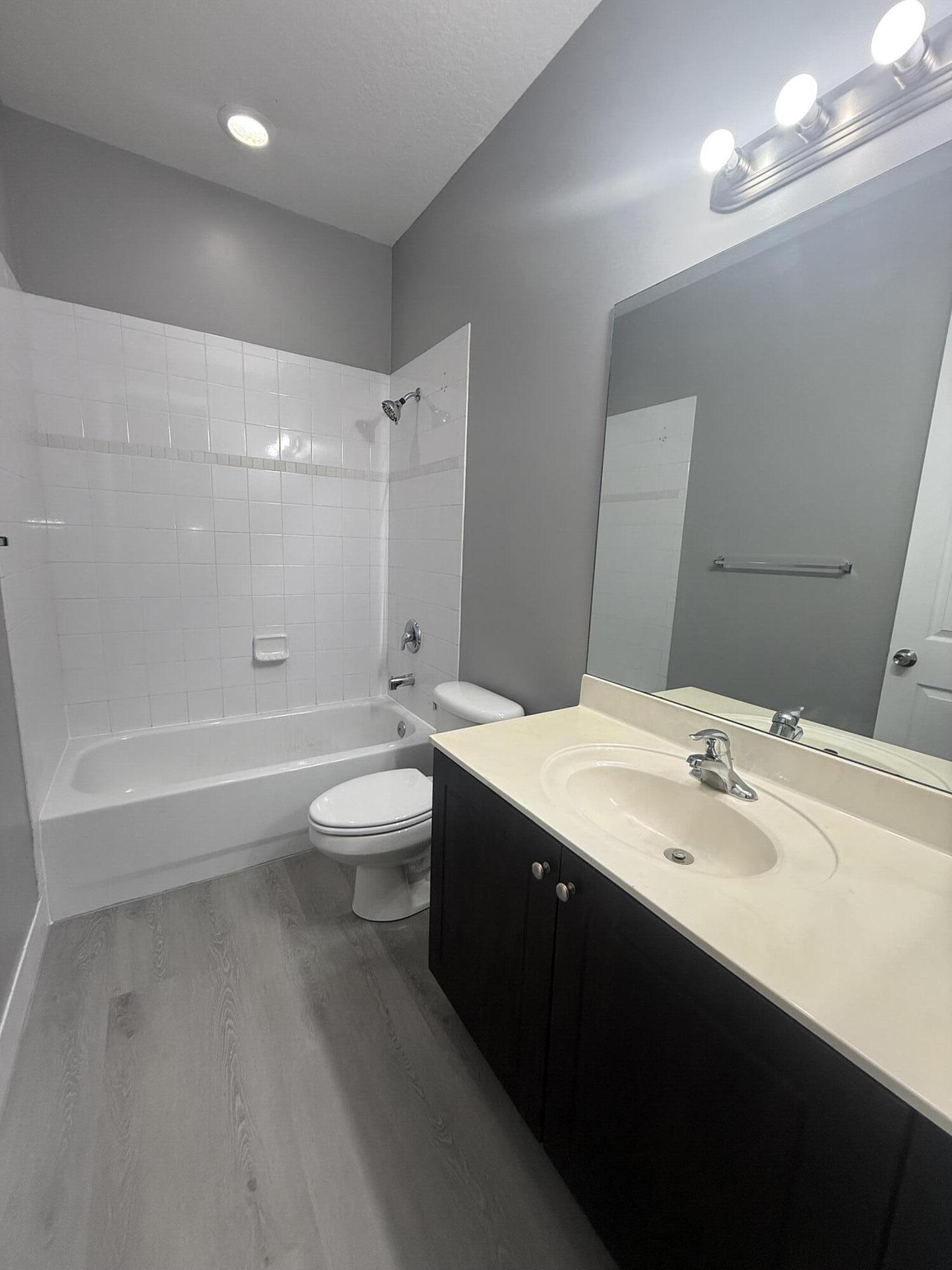 2851 Prospect Road, Unit 502 Tamarac, FL 33309 - Photo 7 of 17 a bathroom with a double vanity sink toilet and shower
