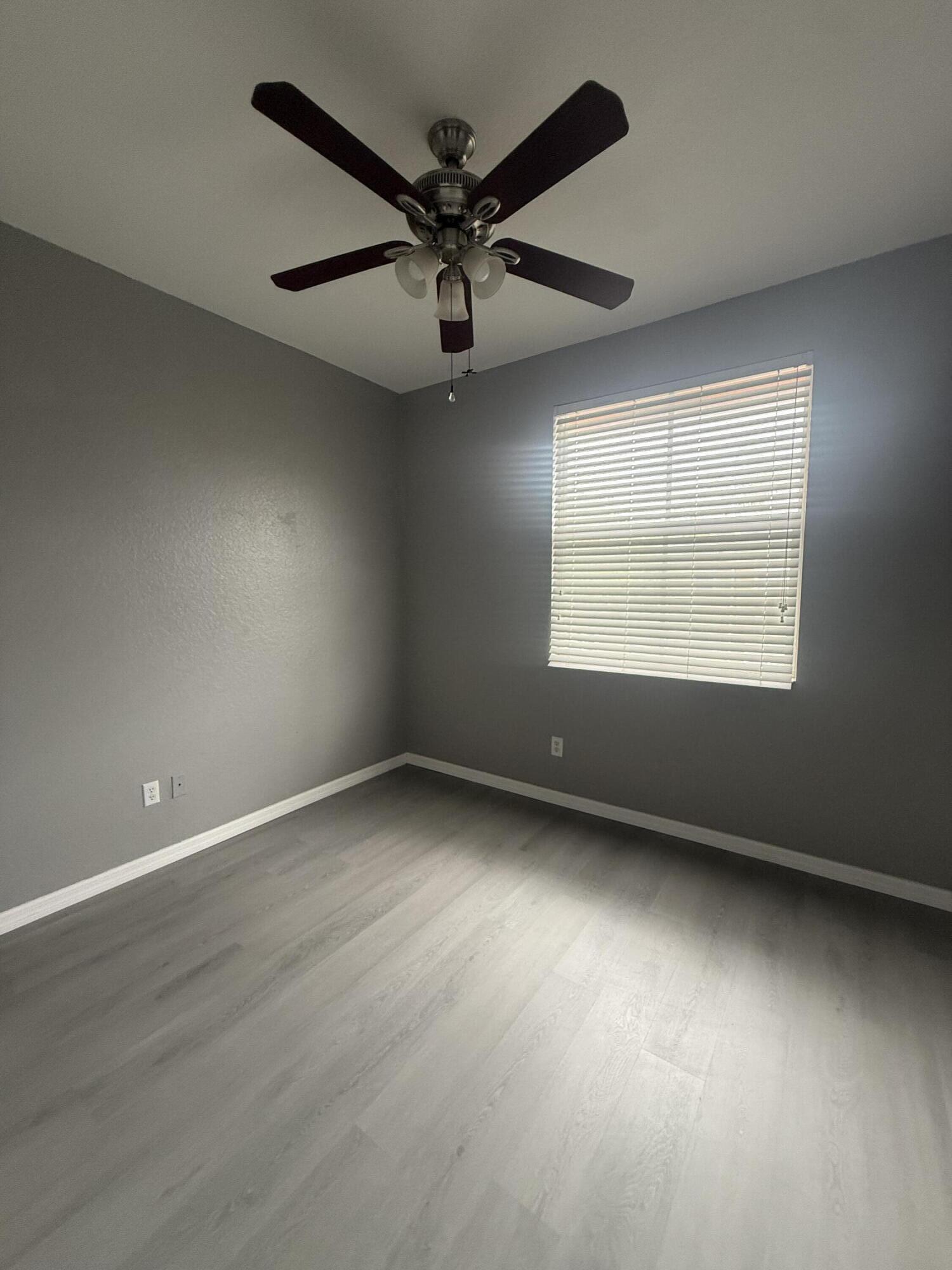 2851 Prospect Road, Unit 502 Tamarac, FL 33309 - Photo 9 of 17 an empty room with a window and a ceiling fan