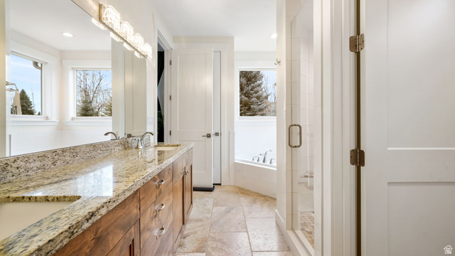 1238 Canyon View Road Midway, UT 84049 - Photo 20 of 36 Bathroom featuring a dual-sink wood-finish vanity with a stone countertop, a large mirror, a decorative light fixture, and a glass-enclosed shower