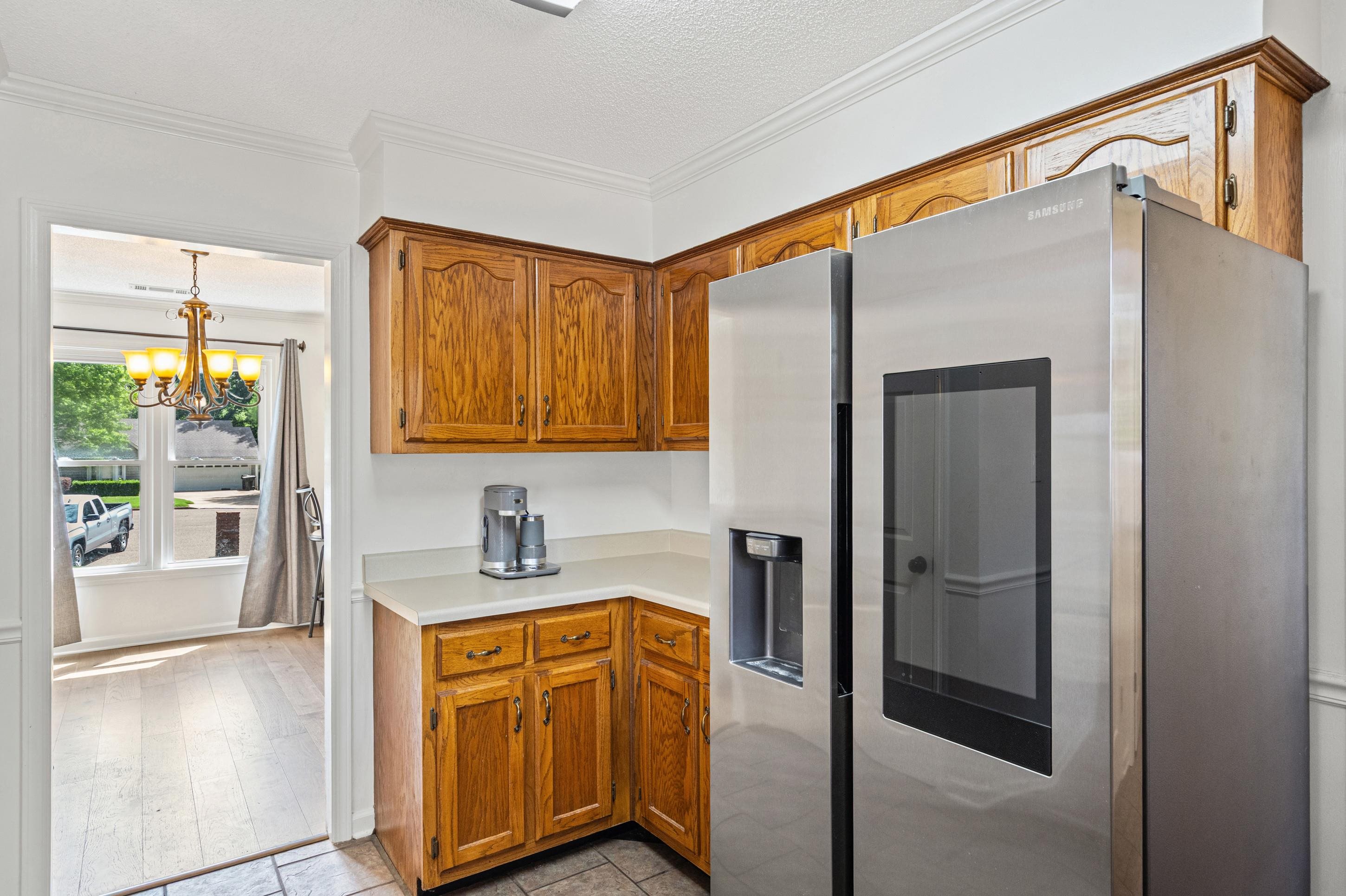 897 Wood Cove Collierville, TN 38017 - Photo 11 of 30 a kitchen with stainless steel appliances granite countertop a refrigerator and a sink