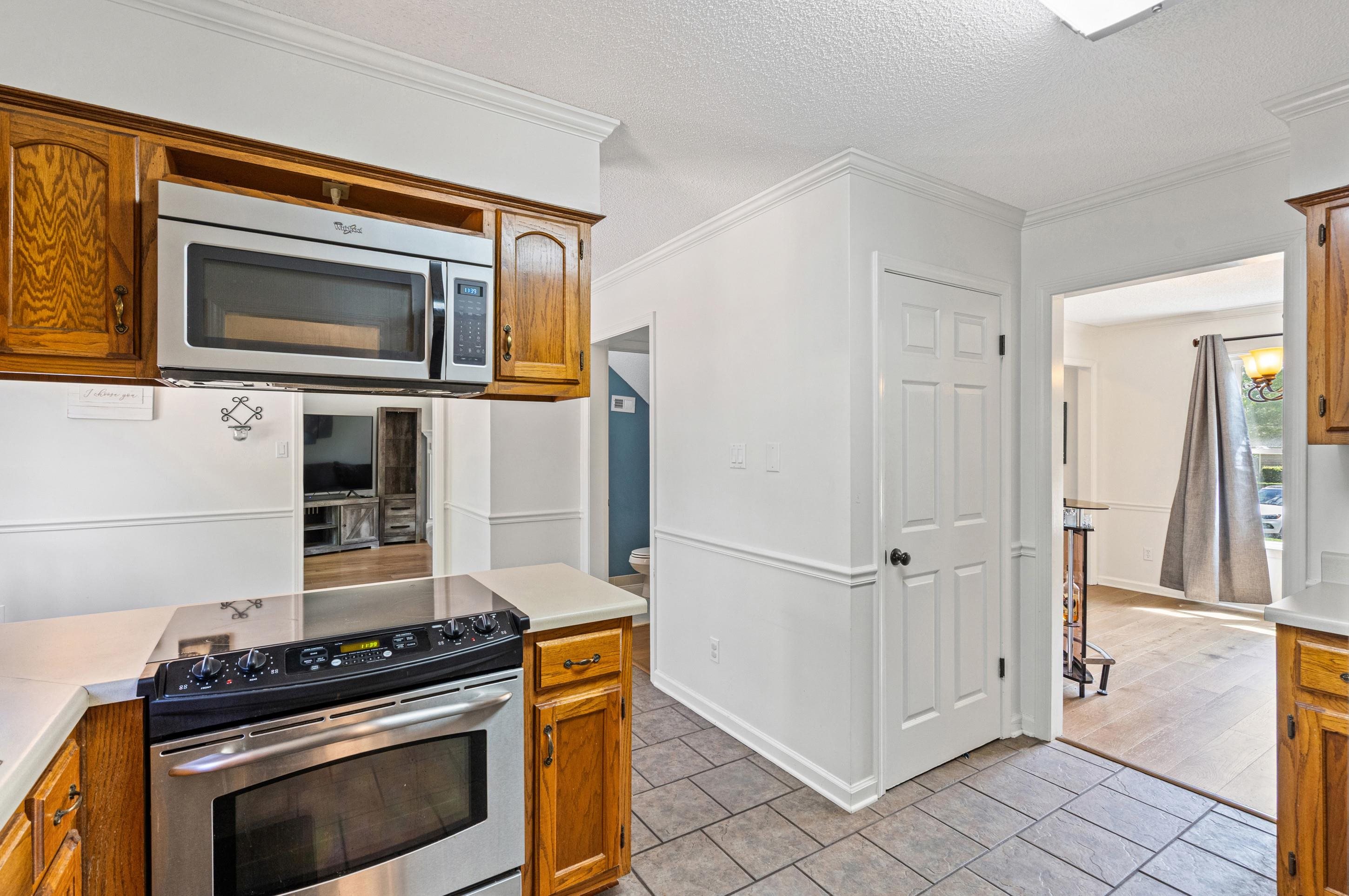 897 Wood Cove Collierville, TN 38017 - Photo 12 of 30 a kitchen with granite countertop cabinets stainless steel appliances and a counter space