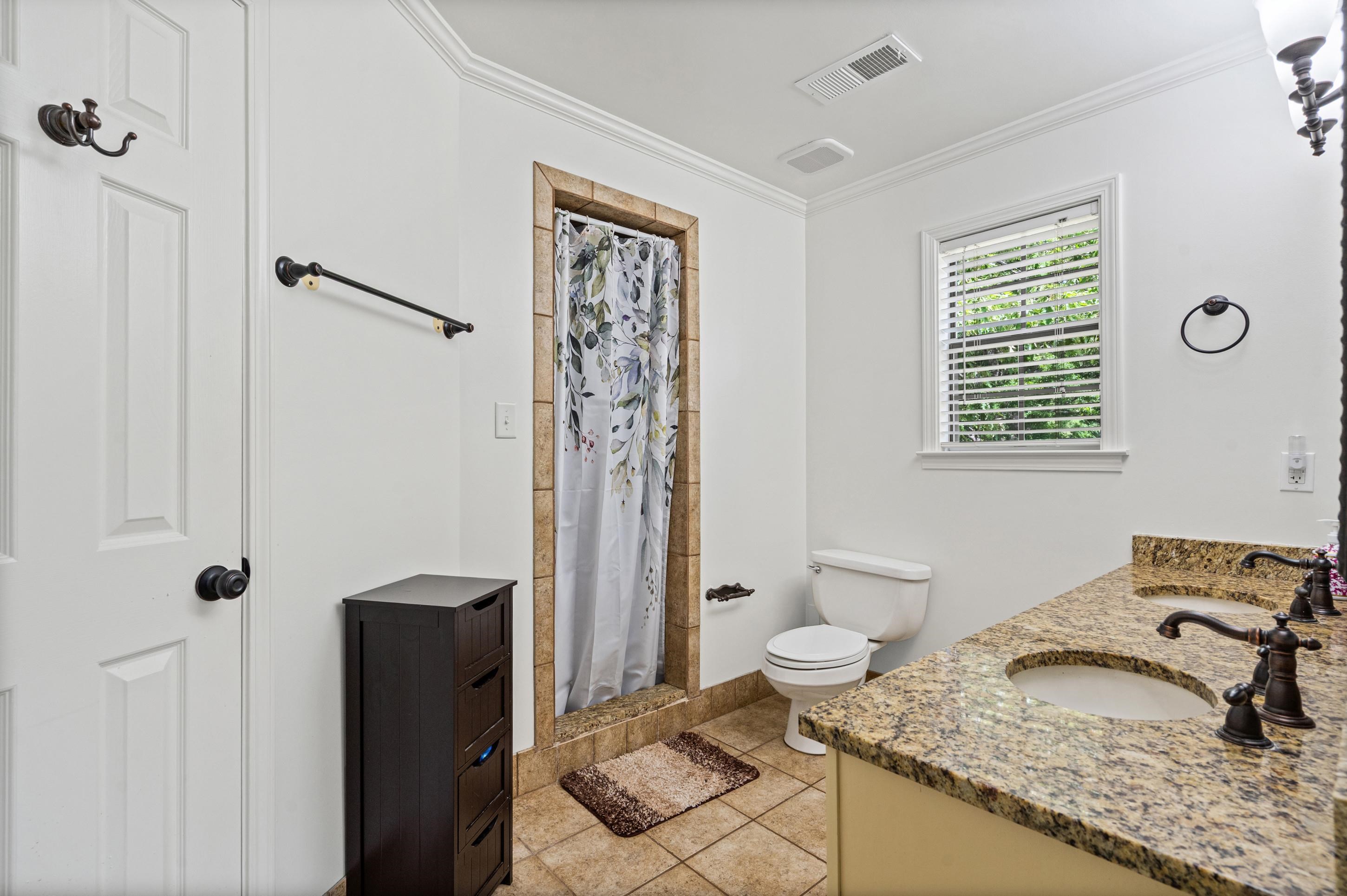 897 Wood Cove Collierville, TN 38017 - Photo 14 of 30 a bathroom with a granite countertop sink toilet and shower