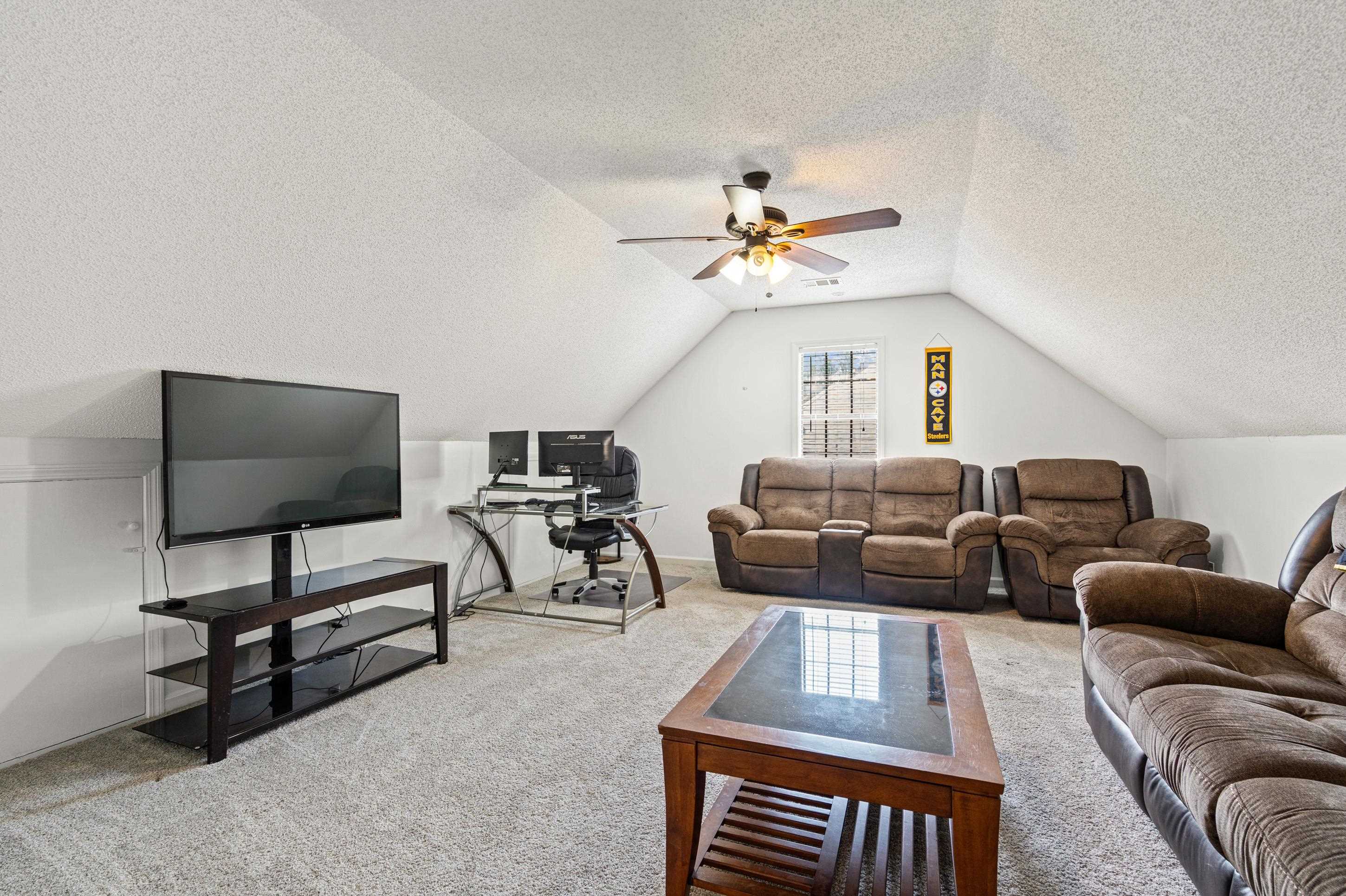 897 Wood Cove Collierville, TN 38017 - Photo 19 of 30 a living room with furniture a ceiling fan a rug and a window