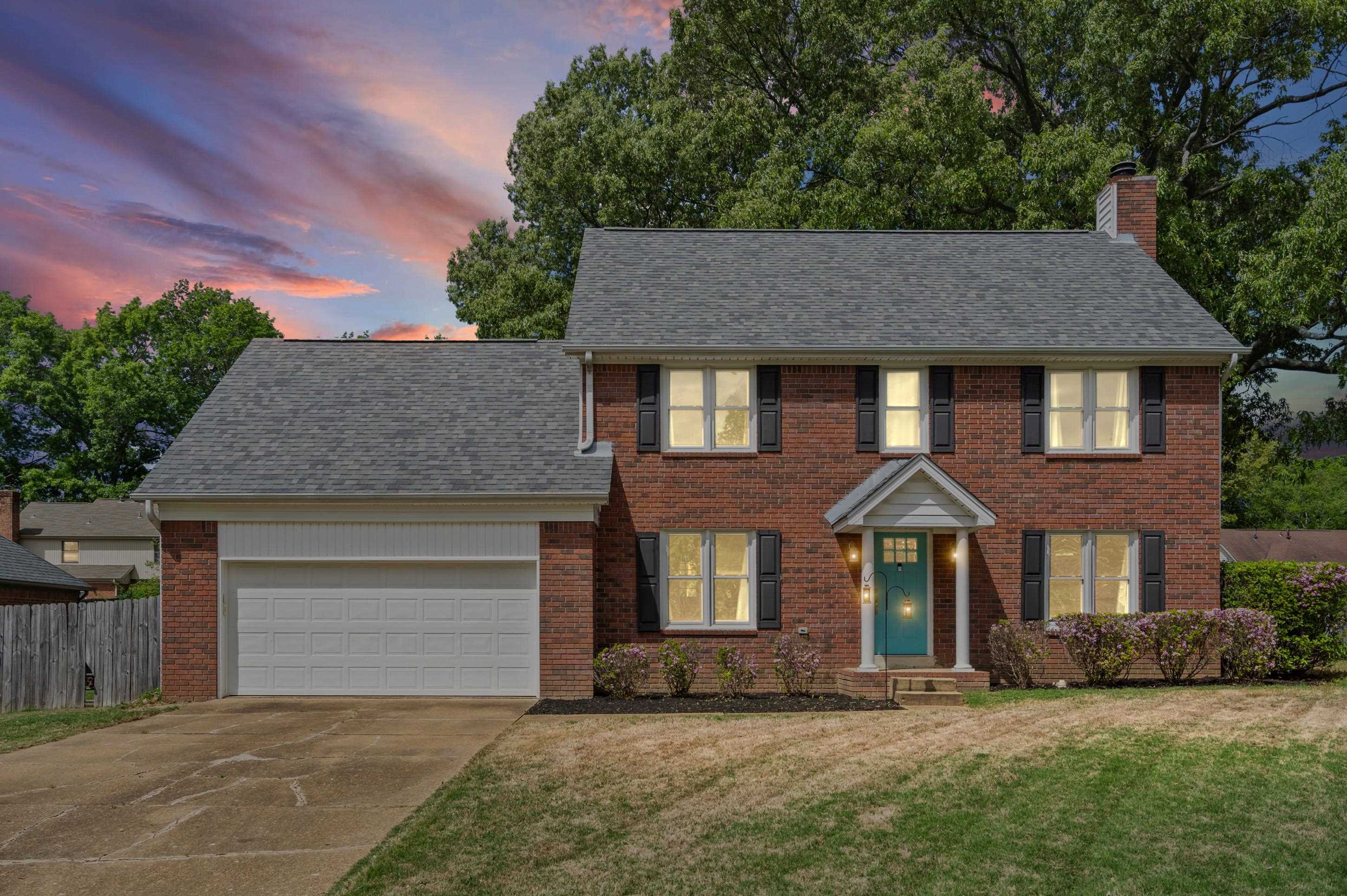 897 Wood Cove Collierville, TN 38017 - Photo 2 of 30 a front view of a house with a yard and garage