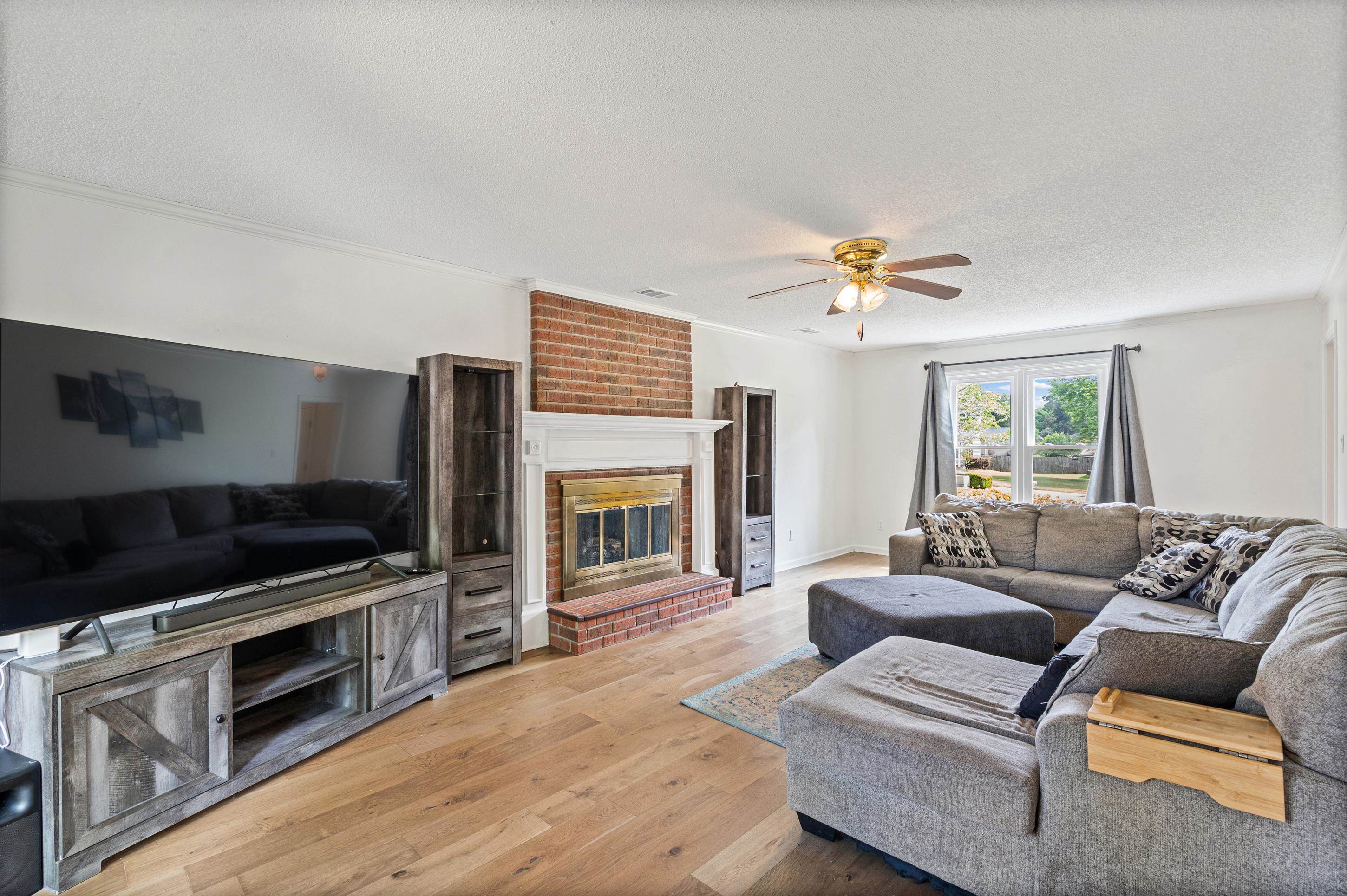 897 Wood Cove Collierville, TN 38017 - Photo 7 of 30 a living room with furniture a fireplace and a flat screen tv