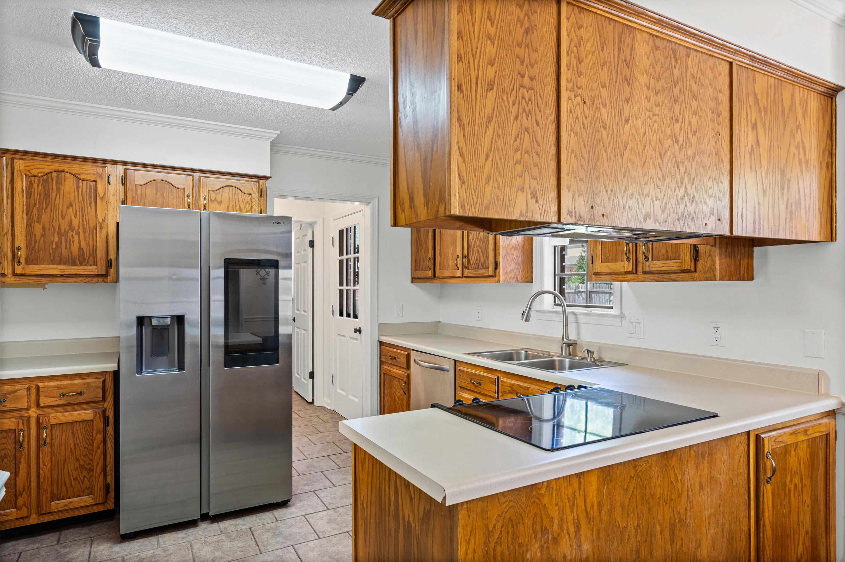 897 Wood Cove Collierville, TN 38017 - Photo 9 of 30 a kitchen with stainless steel appliances granite countertop a sink a stove and refrigerator