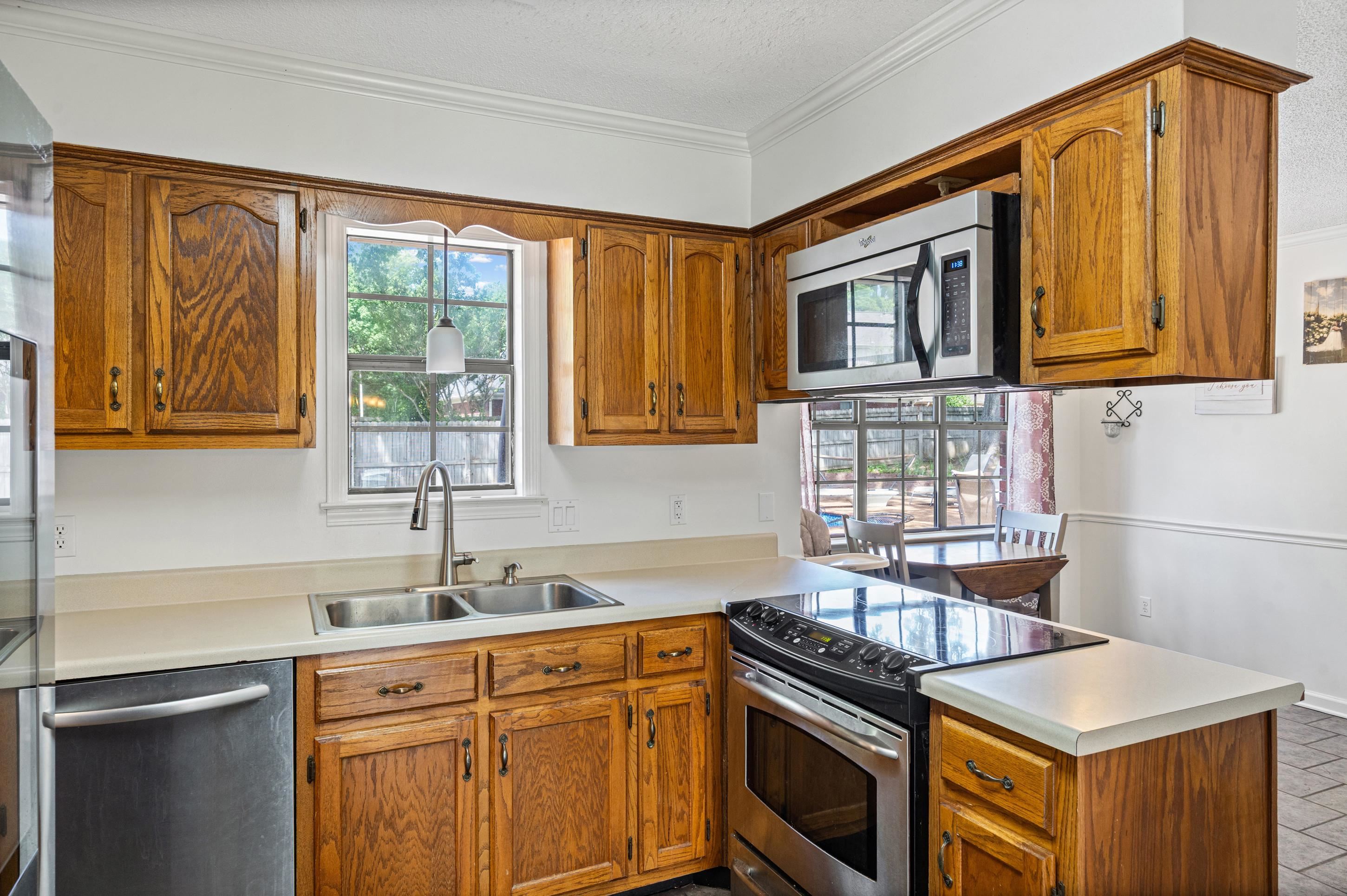 897 Wood Cove Collierville, TN 38017 - Photo 10 of 30 a kitchen with granite countertop a sink stove and cabinets