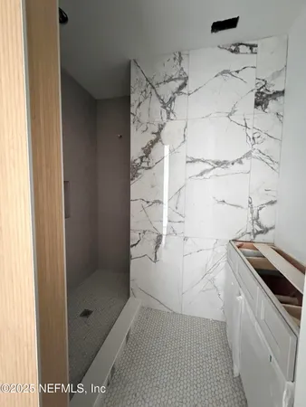 a view of an empty room with window and cabinet