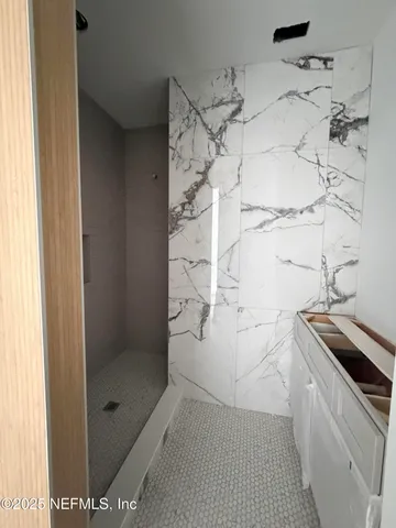 a view of an empty room with window and cabinet