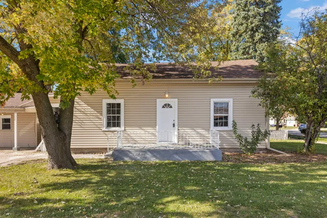 a backyard of a house with yard and tree