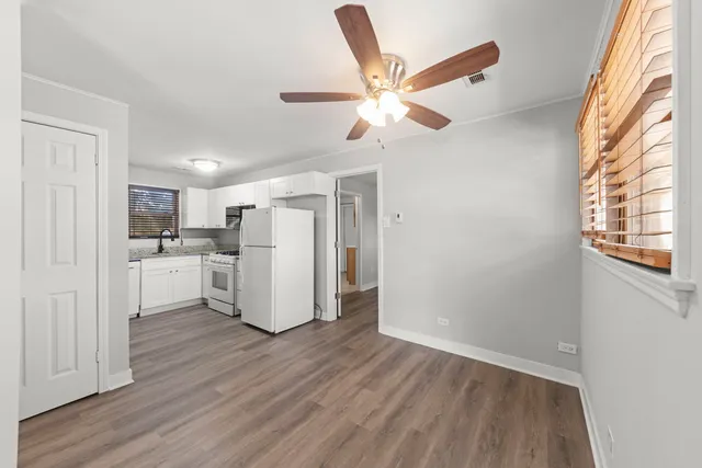 a view of a kitchen with wooden floor
