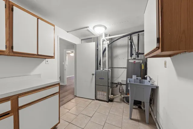 a kitchen with cabinets and a refrigerator