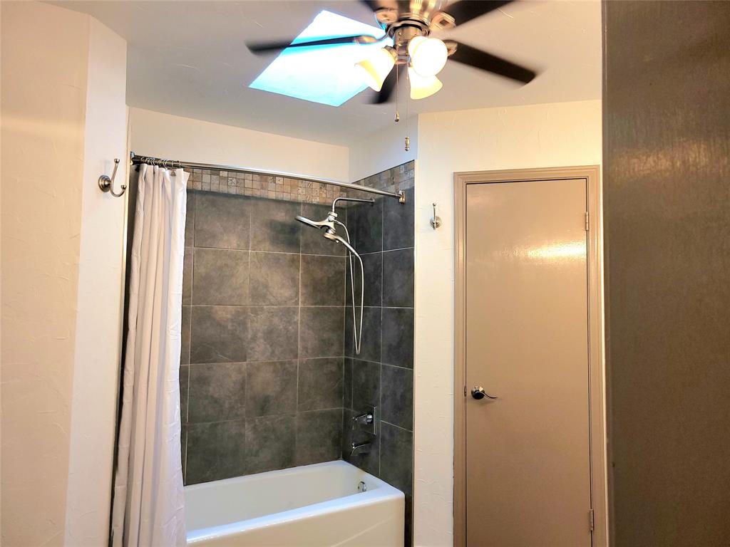 912 North Dove Road Grapevine, TX 76051 - Photo 23 of 36 a bathroom with a shower and a bathtub